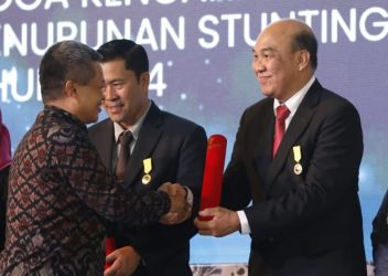 Direktur PT Riau Andalan Pulp and Paper (RAPP) Mulia Nauli menerima penghargaan Dharma Karya Kencana (DKK) dari Kepala BKKBN RI, Hasto Wardoyo pada perayaan Harganas di Semarang, Jawa Tengah.